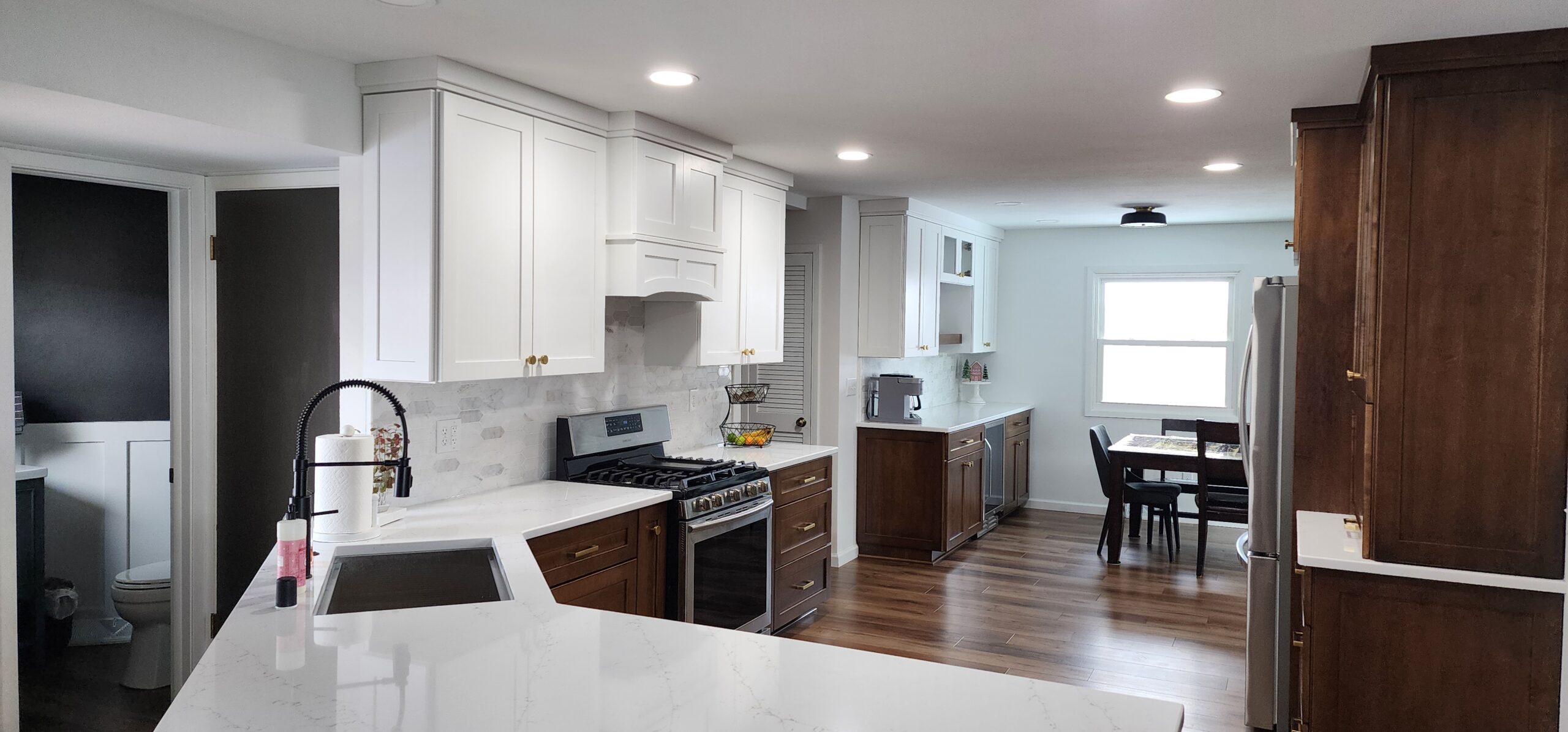 Modern remodeled kitchen with quartz counters and two-tone cabinets